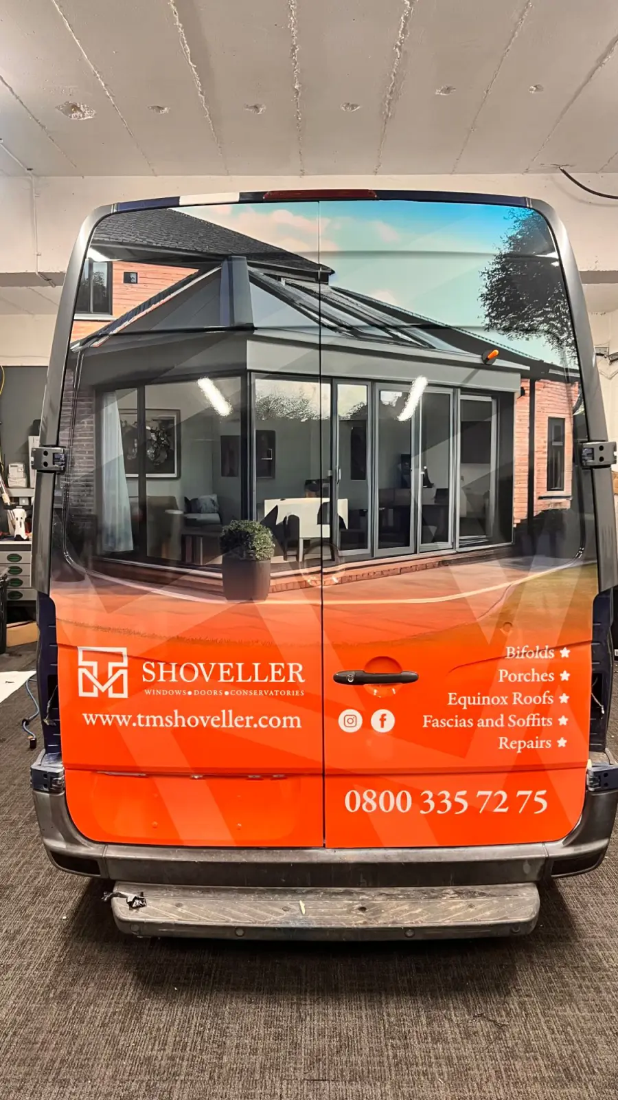 Rear doors of the TM Shoveller van in the workshop, showing the full conservatory image