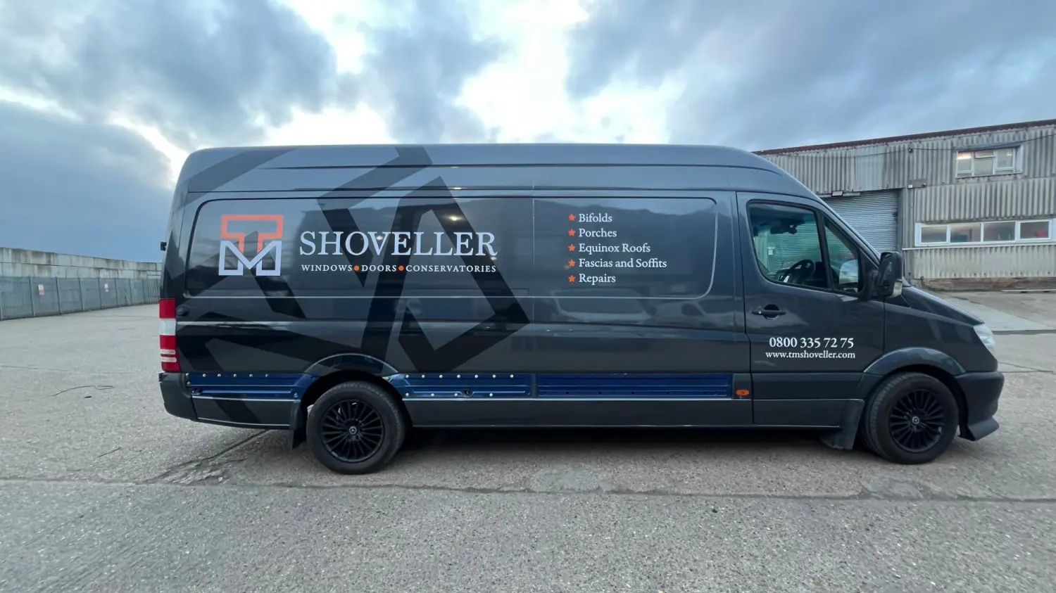 Side of the TM Shoveller van with the logo, services list and phone number